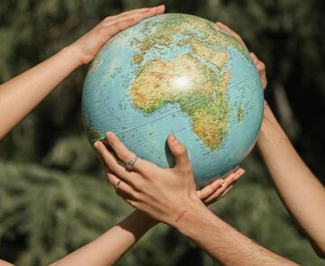 People holding a globe together